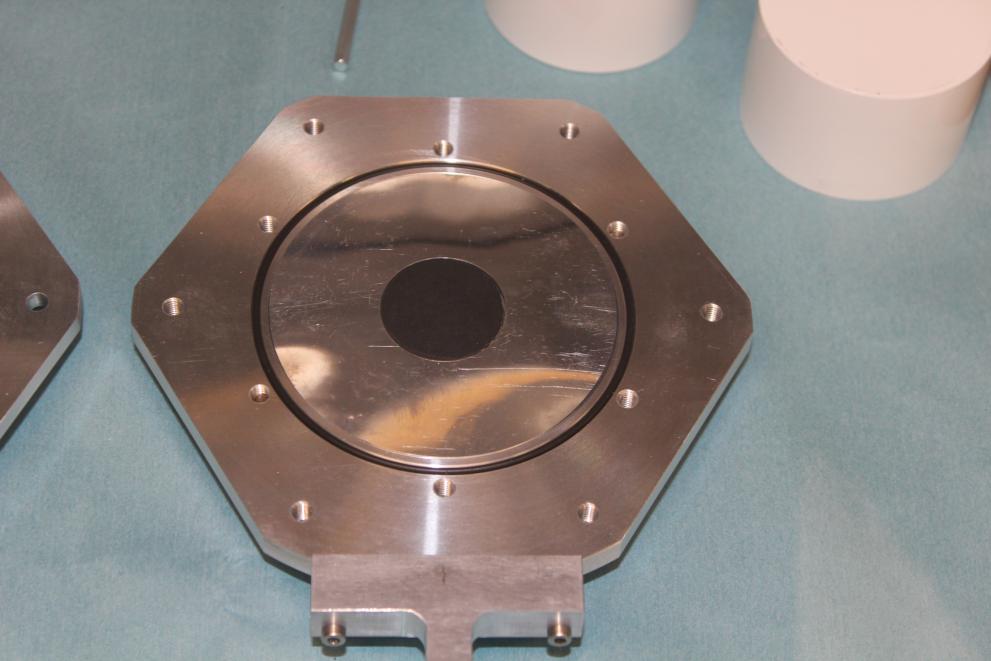 233U disc with a diameter of 30 mm and thickness of 0.64 mm prepared by punching and mounted in a measurement holder with 50 µm Al foil