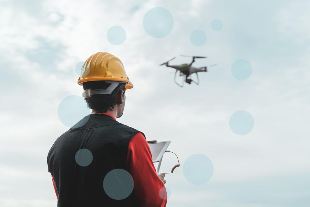 Male engineer monitoring construction site with drone