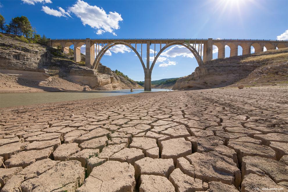 Landscape of dry earth ground and viaduct, extreme drought in Entrepenas reservoir, in Guadalajara, Spain.