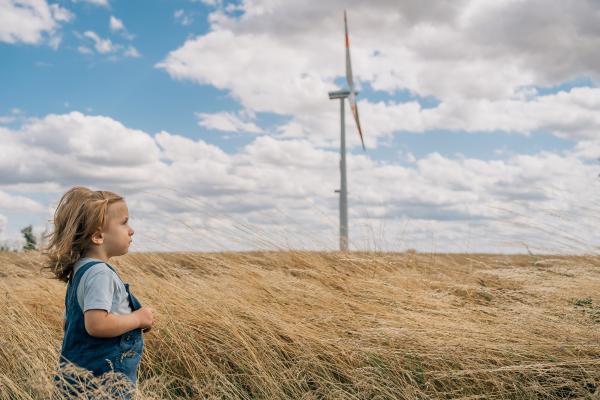 Image of a boy in a field with a windmill
