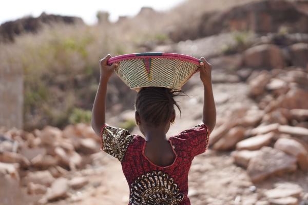 Girl carrying a basket with food