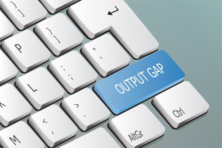 A computer keyboard with "Output gap" written in one of the keys